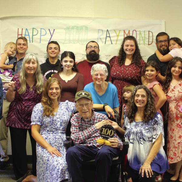 EVERYONE LOVES RAYMOND: Family and friends gathered at Focused Care on Saturday to celebrate the upcoming 100th birthday of Raymond Talbott. A World War II veteran and Purple Heart recipient, Talbott is pictured above surrounded by family and loved ones. Photo by Grant Lengefeld