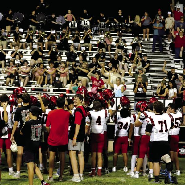 SCHOOL SONG SALUTE: The Bulldogs and their fans raise their finger and sing the school song after traveling to Brady and watching the Hamilton Bulldog football team win 34-17. Photo by Tracy Cox