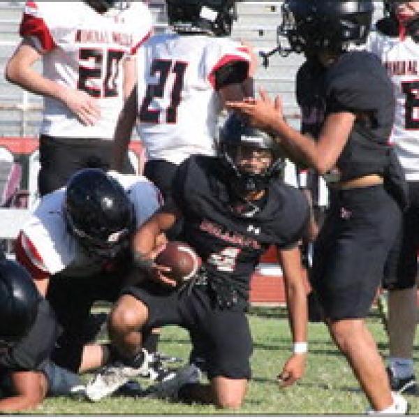 FIRST DOWN ALEMAN: Aaron Aleman (No. 4) gets up after securing a first down for the freshman football team Oct. 15. He would later score Hamilton’s lone touchdown after several carries. Photo by Jaxon Hansard