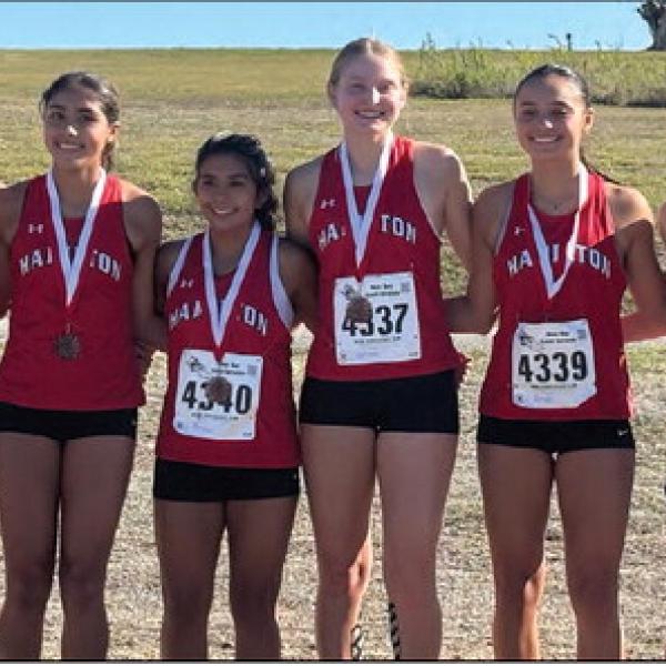 The Varsity girls take third place at the 22nd annual Mona Gloff Invitational cross country meet at home. Photo by Jaxon Hansard