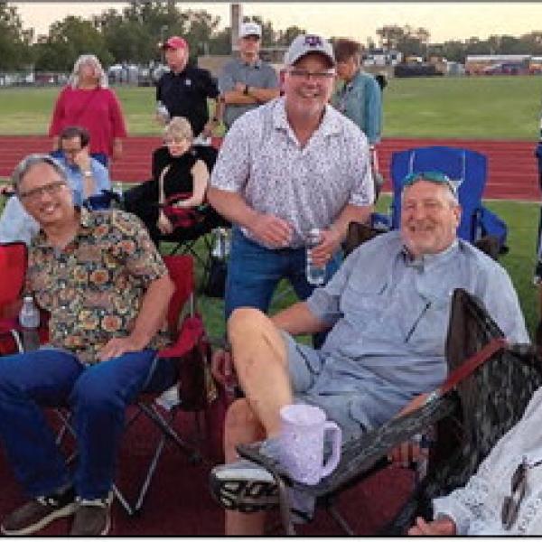 Hamilton High School classes from 1971 to 1986 met at the park at the north end of Kooken Field to eat, drink and trade stories before sitting by the south end zone of the football field during Hamilton’s homecoming game against Dublin. Photo by Raelene Lam.
