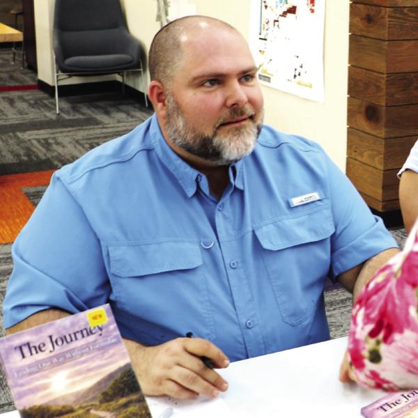 YOUR AUTOGRAPH, PLEASE: Fans of First Baptist Church of Hamilton Pastor and author Drew Dabbs came out in droves last Thursday to purchase a signed copy of his new book, The Journey. The event was held at the Hamilton Public Library. The Journey can now be purchased from Amazon and Dabbs exclaimed that he will “sign a copy anytime, anywhere. Photo by Kate Edwards