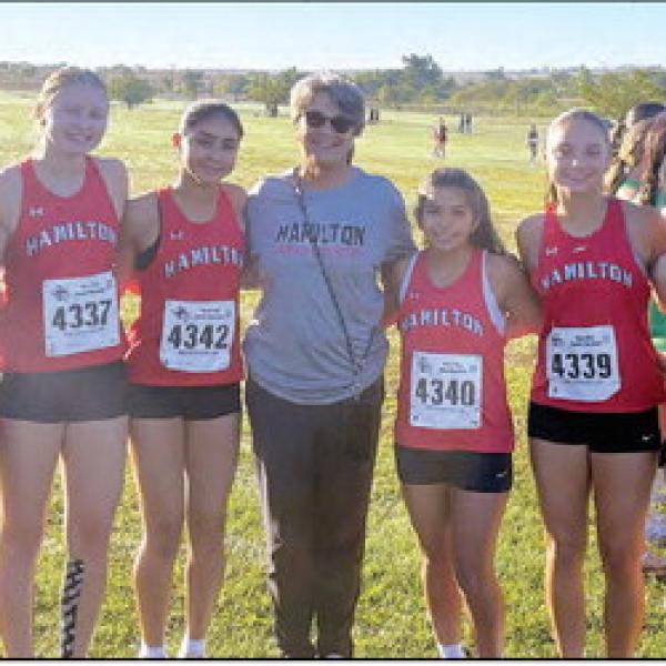 The varsity girls cross country roster snaps a picture with Mona Gloff, one of Hamilton’s most successful coaches and Bulldog, at the 22nd annual Mona Gloff Invitational. The varsity girls placed 3rd as a team and senior Chaska Downs placed first. Pictured are Downs (left), Milagros Moncada, Carolina DeLaGarza, Aleena Ramirez, Gloff, Lila Lozano, Lillian Fletcher, Taylyn Banda and Berlin Bolton. Photo by Jaxon Hansard