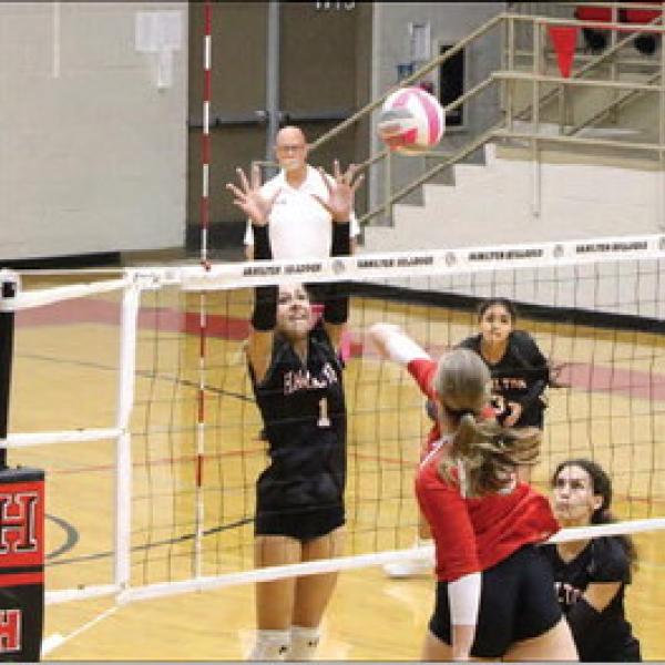 Landry Gardner (No. 1) gives maximum effort on her way up the net to block a Lady Leopard spike. Photos by Jaxon Hansard