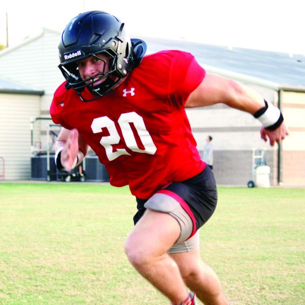 LOVING THE GRIND: Senior Kennon Lee, pictured grinding through offensive drills from his tight end position, will be looking to have another impactful season for the Bulldogs on both sides of the ball. The Dogs are scheduled to face opposing colors for the first time when they host 4A-Div. 2 Hillsboro for a season opening scrimmage this Friday at Kooken Field, beginning at 7 p.m. Photo by Grant Lengefeld