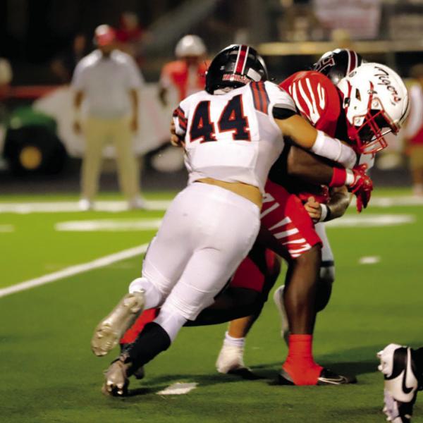 BY THE HORNS: Hamilton senior TE/ILB and steer wrestler Cade Banquinho (#44) got some rodeo reps in with a tackle of one of Bremond’s barreling running backs. The Rodeo back finished the game with 12 tackles, one tackle for loss, and a quarterback pressure. Photo by Tracy Cox