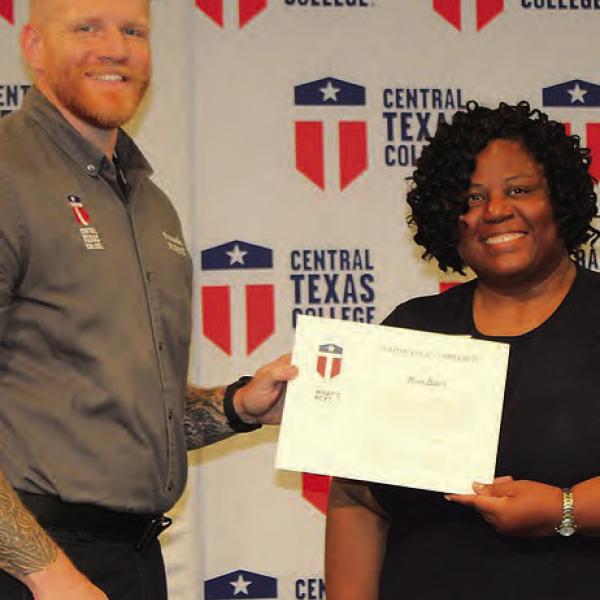 Ross Bates (left) receives his paramedic certificate from CTC Vice Chancellor Dr. Tamara Clunis during the Paramedic Program Course Completion Ceremony. Bates was among 19 students completing the college’s paramedic program and preparing for careers in advanced emergency medical services. Photo Courtesy of Wendy Sledd