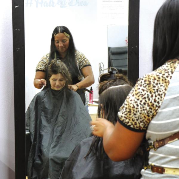 BACK-TO-SCHOOL CUTS: For the tenth consecutive year, free back-to-school haircuts for students are being offered Saturday, Aug. 8, from 8 a.m. to noon at Rejuvenation Station, located at 120 E. Main Street in Hamilton. School supply donations will also be accepted during the event. Organizer Andrea Fletcher is pictured last year administering a back-to-school cut. Photo by Grant Lengefeld