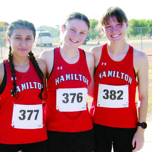 ALL OVER THE COURSE: Hamilton High School Cross Country Lady Dogs finished third as a team at the Zephyr Invitational with all but one Varsity runner placing in the top 30. Pictured left is Milsgros Moncada, who placed 22nd; Chaska Downs, who finished first and Berlin Bolton, who placed 73rd. Photo by Jennifer Bolton