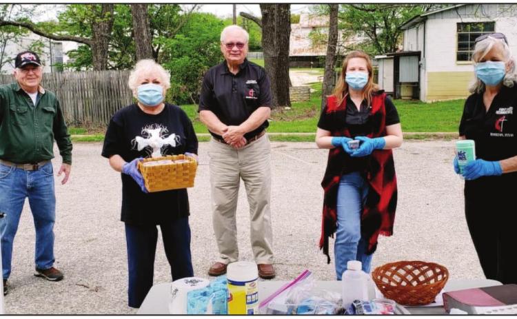 READY TO SERVE- Ben Overton, Charles and Cheryl Clutter, Sam Chambers and Linda McLelland met visitors in the First United Methodist Church parking lot Sunday to offer communion, prayer and toilet tissue.