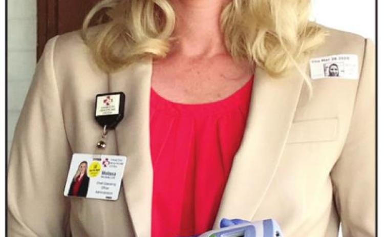 TEMP PLEASE- When Hamilton Hospital District board of directors met last week at Lee Conference Center, they were met at the door by Chief Operating Officer Melissa DeLaGarza, who took temperatures and ensured the board practiced social distancing. Staff Photo