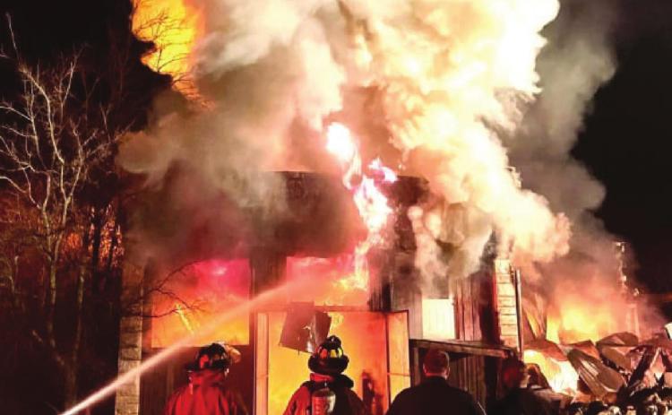 Fire destroys structures in downtown Carlton