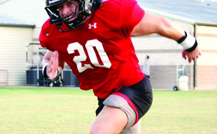 LOVING THE GRIND: Senior Kennon Lee, pictured grinding through offensive drills from his tight end position, will be looking to have another impactful season for the Bulldogs on both sides of the ball. The Dogs are scheduled to face opposing colors for the first time when they host 4A-Div. 2 Hillsboro for a season opening scrimmage this Friday at Kooken Field, beginning at 7 p.m. Photo by Grant Lengefeld