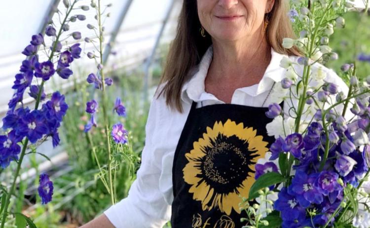 BEAUTIFUL BLOOMS - Aleman Acres owner and grower Lisa Schrank in one of three high tunnels with flowers grown at the farm.