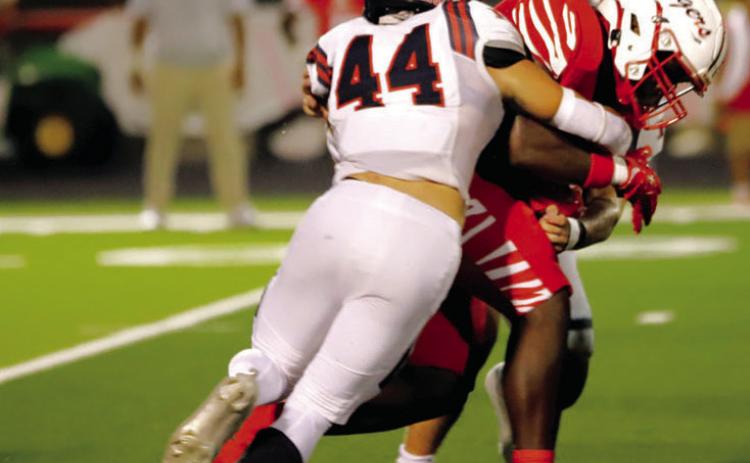 BY THE HORNS: Hamilton senior TE/ILB and steer wrestler Cade Banquinho (#44) got some rodeo reps in with a tackle of one of Bremond’s barreling running backs. The Rodeo back finished the game with 12 tackles, one tackle for loss, and a quarterback pressure. Photo by Tracy Cox