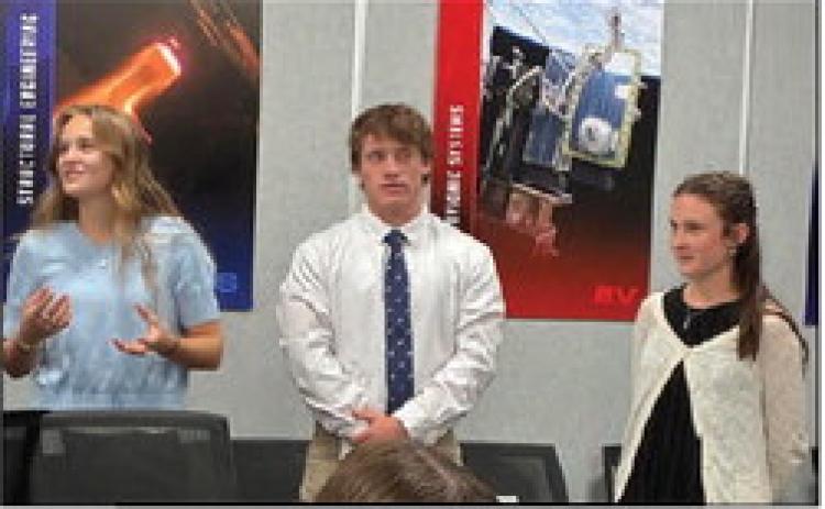 The research and development 2 team, Bree Harle (left), Kennon Lee and Chaska Downs, give their flight profile presentation Oct. 15 for a SystemsGo launch event this spring. Courtesy photo