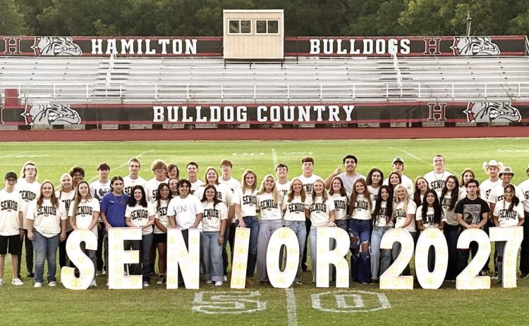 In keeping with a tradition started in 2023 by the then Hamilton High School Class of 2024, Hamilton’s incoming senior Class of 2027 gathered at sunrise last Friday morning at Kooken Field for a time of fellowship and prayer over the upcoming school year. Following a blessing by St. John Lutheran Church Pastor Aaron Kalbas, the HHS seniors spread blankets across the field and enjoyed a picnic-style breakfast prepared and served by their parents. Photo by Grant Lengefeld